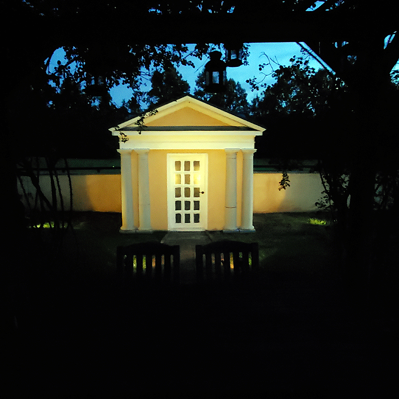 Orchard pavilion glowing in the twilight