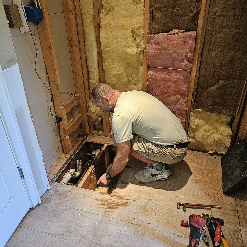 Tamas destroys the old shower and tub in the Guest House